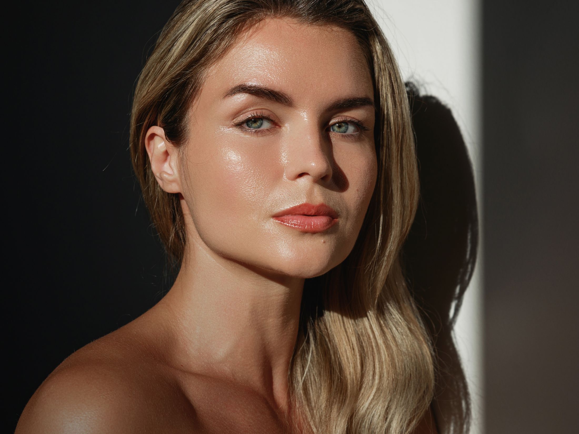 Model with glowing skin in natural light.